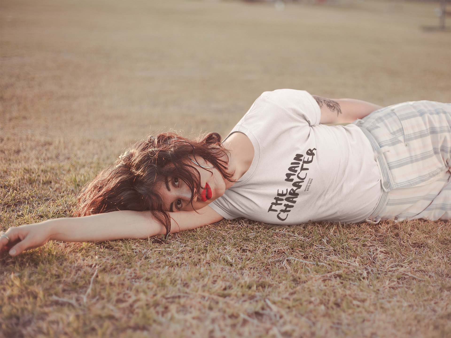 t-shirt-mockup-of-a-girl-lying-down-on-the-grass-19743.png